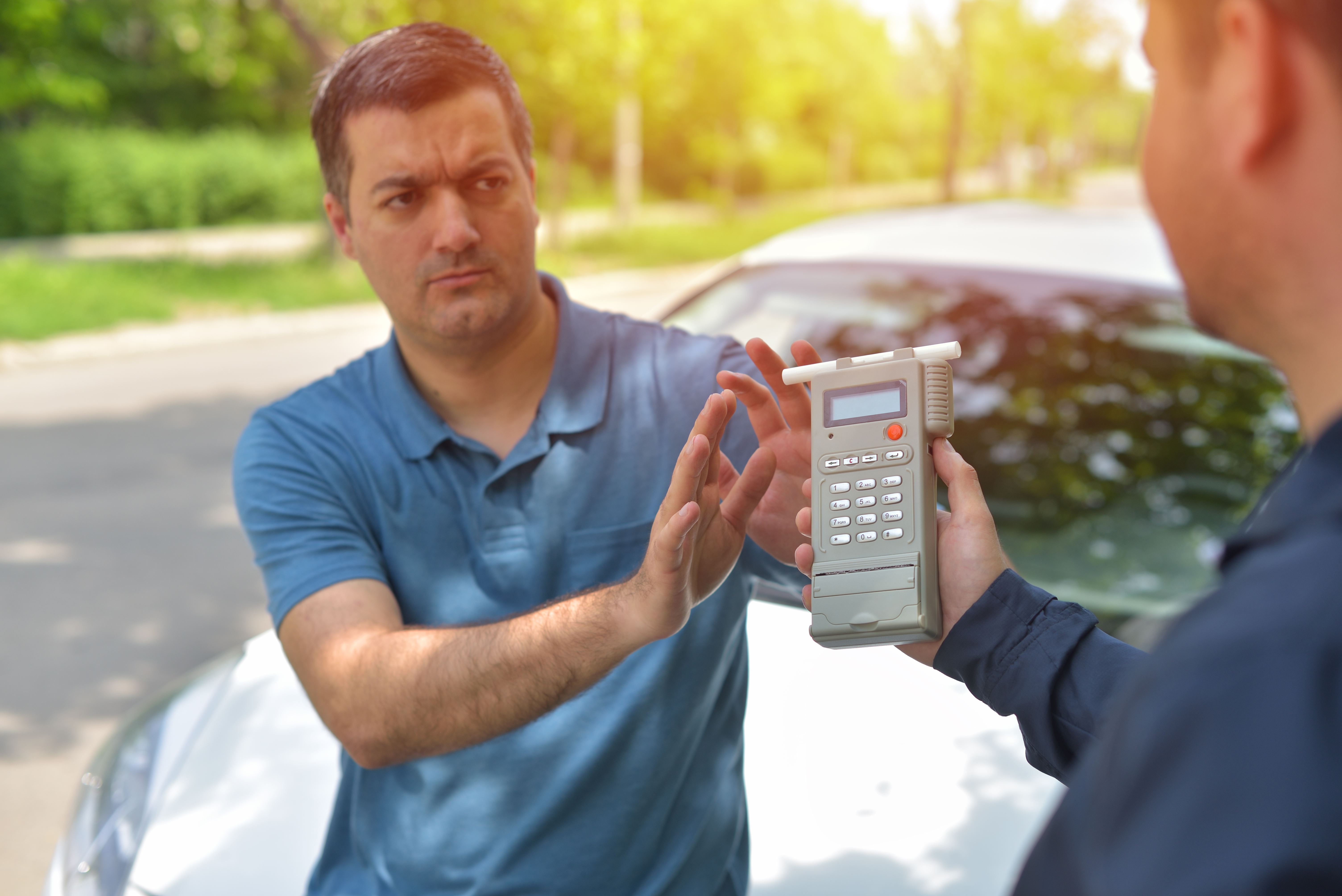 Person trying to refuse taking a breathalyzer test